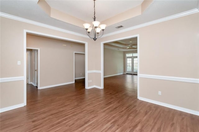 interior space with a tray ceiling, crown molding, french doors, and dark hardwood / wood-style floors