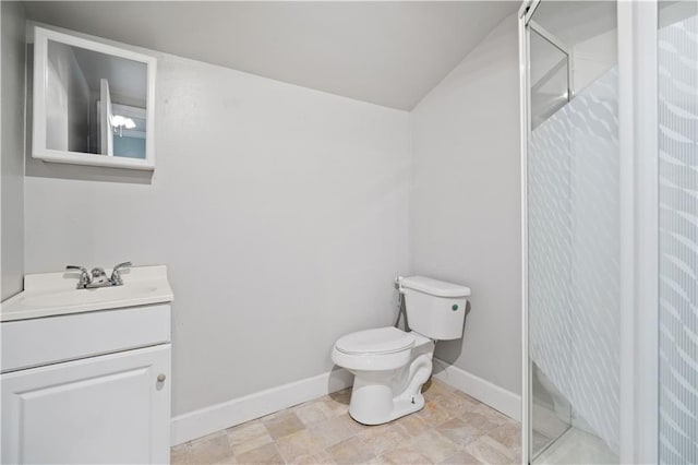 bathroom with vanity, toilet, and walk in shower