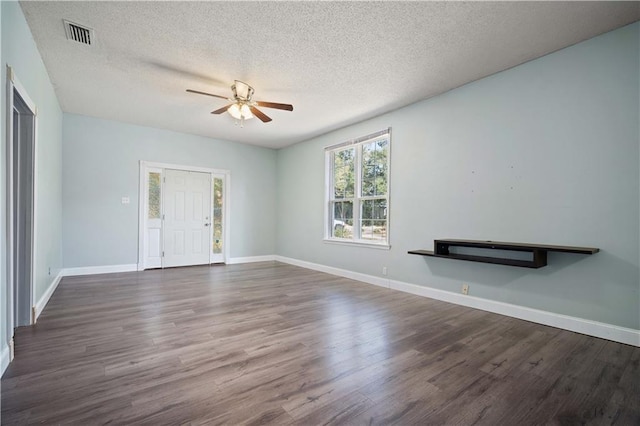 unfurnished living room with ceiling fan, dark wood-type flooring, and a textured ceiling