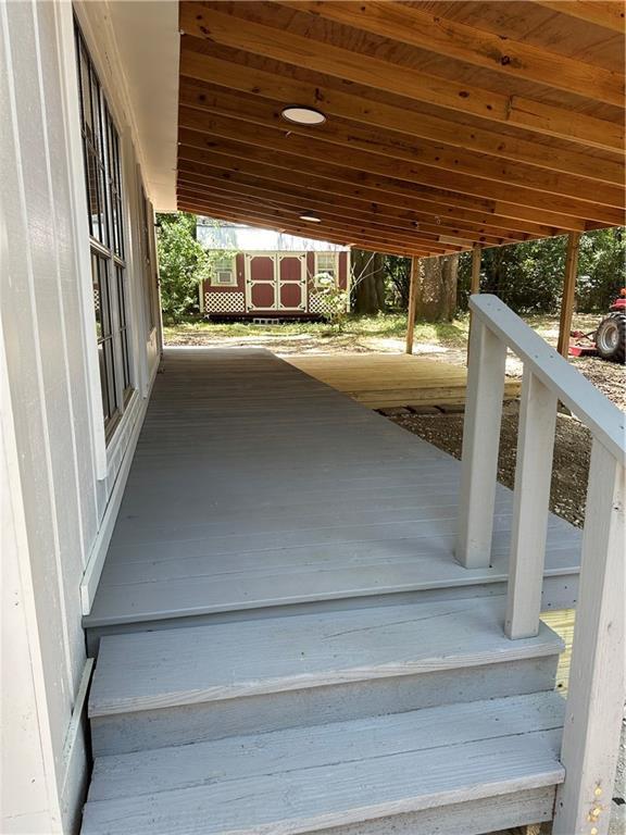315 Thunderbird Dr, Satsuma, AL 36572 - wooden terrace with a carport