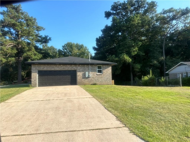 view of front of house with a garage and a front lawn