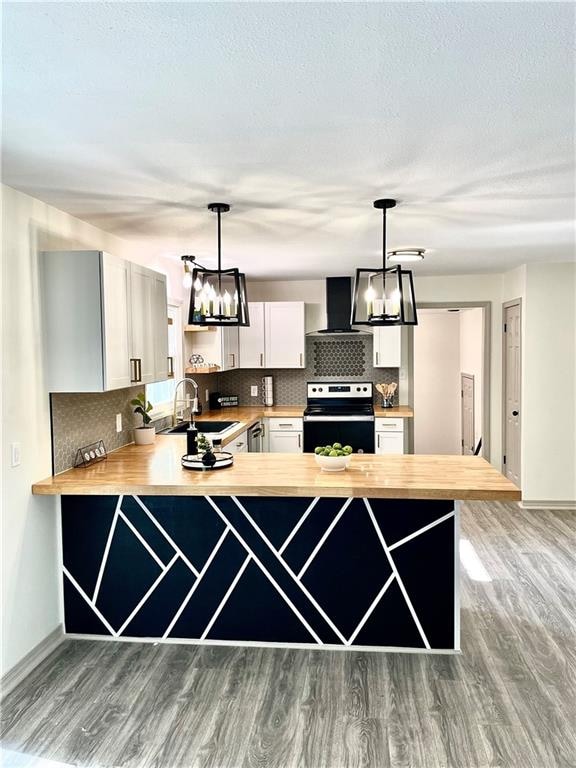 kitchen with decorative light fixtures, sink, white cabinets, and electric stove