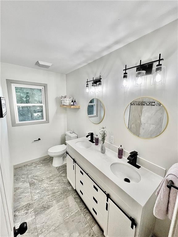 bathroom with vanity and toilet