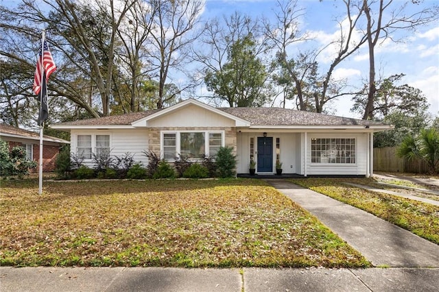 ranch-style home featuring a front yard