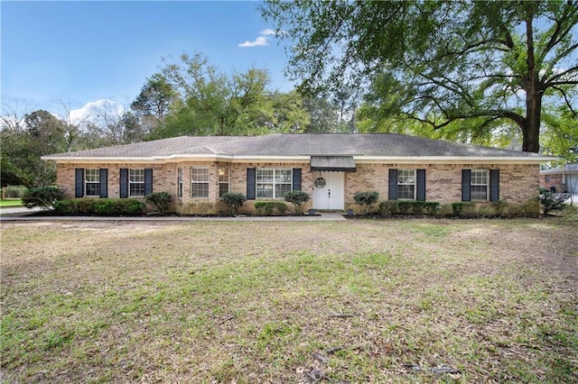 ranch-style house featuring brick siding and a front lawn