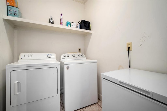 clothes washing area with light tile patterned floors, laundry area, and separate washer and dryer