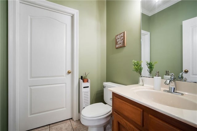 bathroom with tile patterned flooring, crown molding, vanity, and toilet