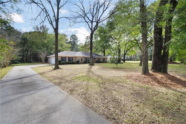 ranch-style home featuring a garage and concrete driveway