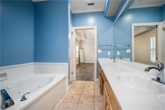 bathroom featuring crown molding, tile patterned flooring, visible vents, and a sink