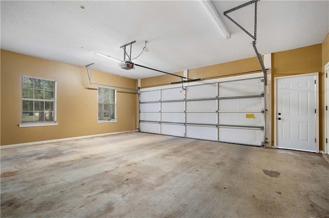 garage with baseboards and a garage door opener