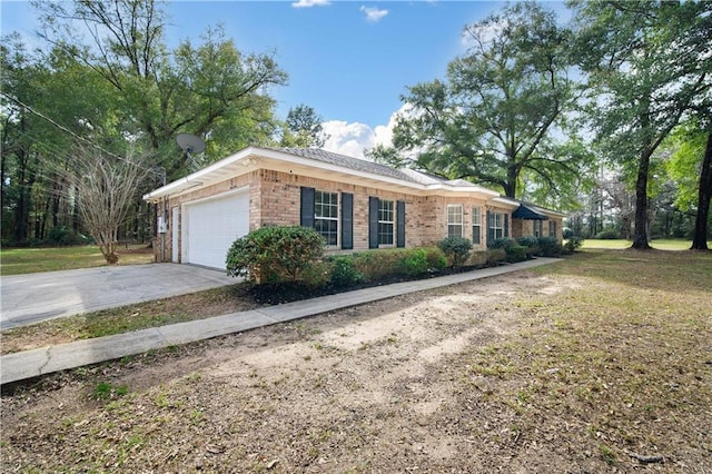 view of home's exterior with a garage, a yard, brick siding, and driveway