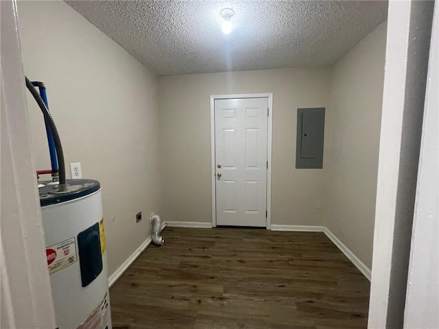 laundry room featuring electric panel, electric water heater, a textured ceiling, wood finished floors, and baseboards