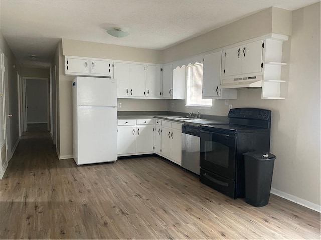 kitchen featuring under cabinet range hood, stainless steel dishwasher, wood finished floors, freestanding refrigerator, and black / electric stove