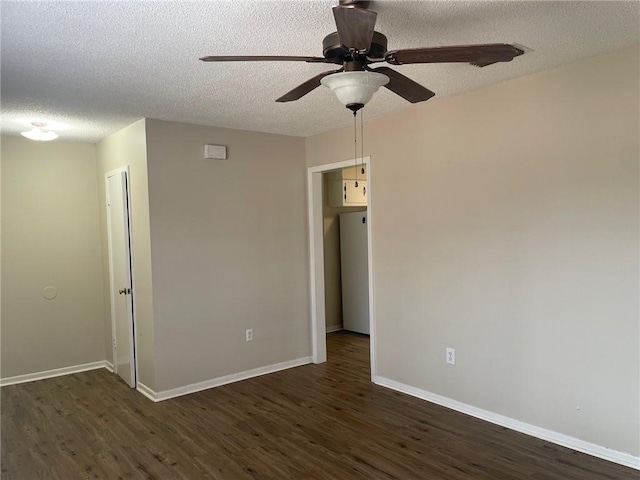 spare room with baseboards, a textured ceiling, ceiling fan, and dark wood-style flooring