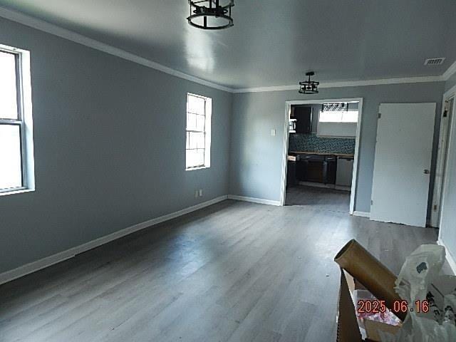1021 Cherry St, Mobile, AL 36610 - unfurnished living room featuring crown molding, wood finished floors, and healthy amount of natural light