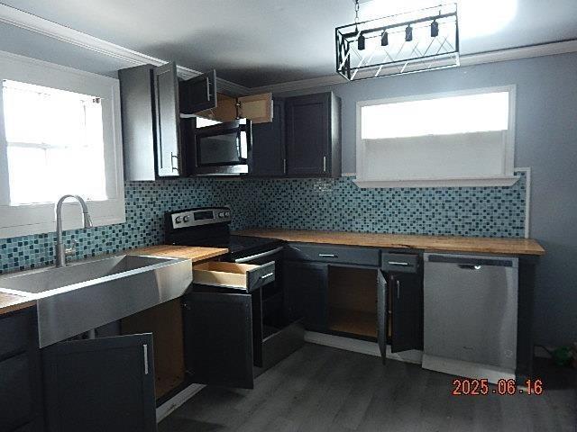 1021 Cherry St, Mobile, AL 36610 - kitchen with appliances with stainless steel finishes, dark wood finished floors, healthy amount of natural light, tasteful backsplash, and ornamental molding