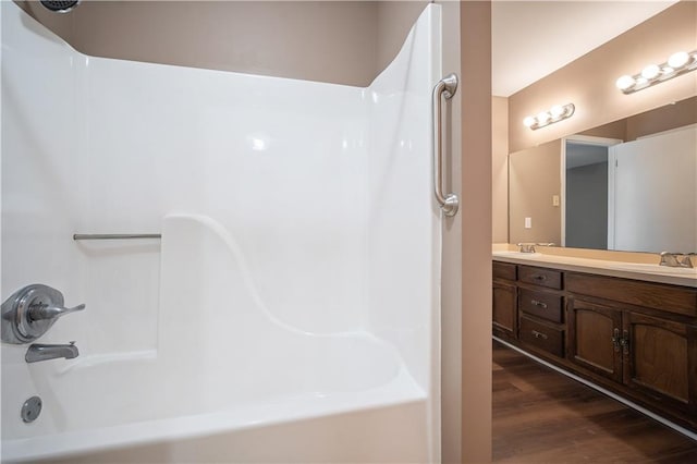 5902 Reams Dr S, Mobile, AL 36608 - bathroom with washtub / shower combination, double vanity, and wood finished floors