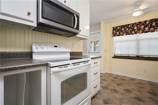 5902 Reams Dr S, Mobile, AL 36608 - kitchen featuring electric range, stainless steel microwave, dark countertops, white cabinetry, and a ceiling fan