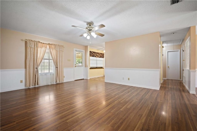 5902 Reams Dr S, Mobile, AL 36608 - empty room with a ceiling fan, attic access, wood finished floors, a textured ceiling, and a wainscoted wall