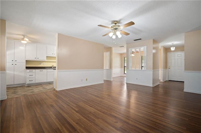 5902 Reams Dr S, Mobile, AL 36608 - unfurnished living room with a ceiling fan, dark wood-type flooring, and a textured ceiling