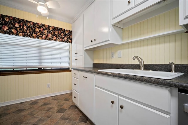 5902 Reams Dr S, Mobile, AL 36608 - kitchen with dark countertops, white cabinets, stone finish flooring, ceiling fan, and crown molding