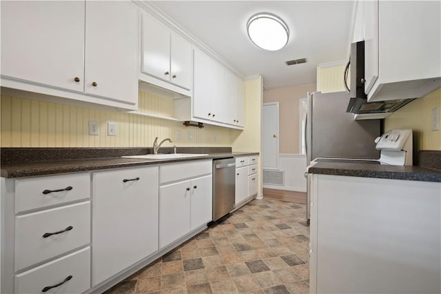 5902 Reams Dr S, Mobile, AL 36608 - kitchen with stainless steel appliances, white cabinets, dark countertops, and stone finish flooring