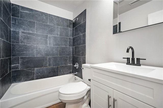 full bathroom featuring washtub / shower combination, vanity, and toilet