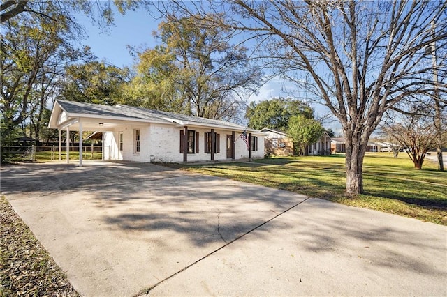 single story home with a front yard and a carport