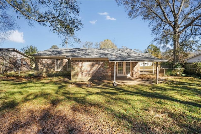 rear view of property with a patio area, a yard, and french doors