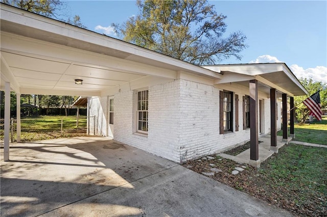 view of home's exterior with a carport and a yard