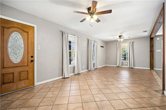 tiled entrance foyer featuring ceiling fan