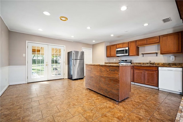 kitchen with sink, dark stone countertops, stainless steel appliances, and french doors