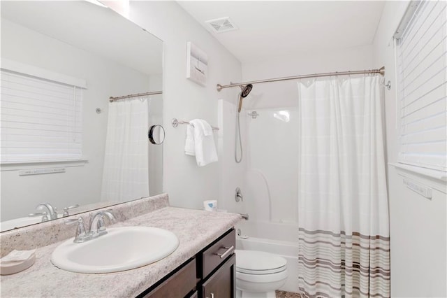 full bathroom with vanity, toilet, and shower / tub combo with curtain