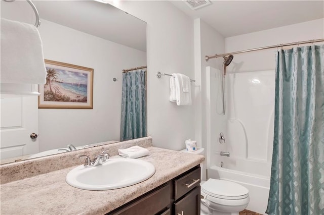 full bathroom with vanity, shower / bath combo, and toilet