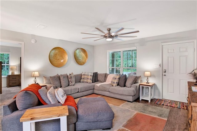 living room featuring ceiling fan and light wood-type flooring