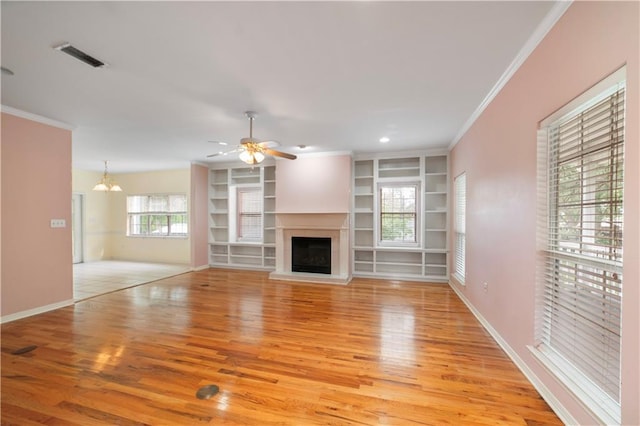 5039 Cole Dr W, Mobile, AL 36619 - unfurnished living room with visible vents, ornamental molding, light wood finished floors, and a fireplace with raised hearth