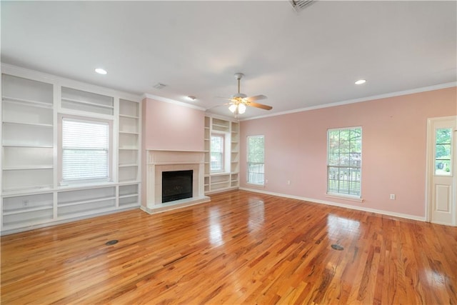 5039 Cole Dr W, Mobile, AL 36619 - unfurnished living room with baseboards, a ceiling fan, light wood-style flooring, and built in shelves