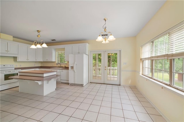 5039 Cole Dr W, Mobile, AL 36619 - kitchen with an inviting chandelier, white cabinets, and white appliances