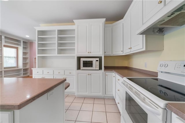 5039 Cole Dr W, Mobile, AL 36619 - kitchen with white cabinets, light tile patterned flooring, open shelves, white appliances, and under cabinet range hood