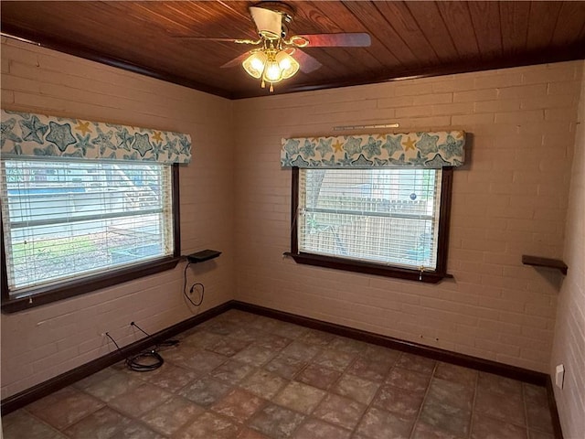 408 Chenault Ave, Dauphin Island, AL 36528 - spare room with wooden ceiling, ceiling fan, tile patterned floors, and brick wall