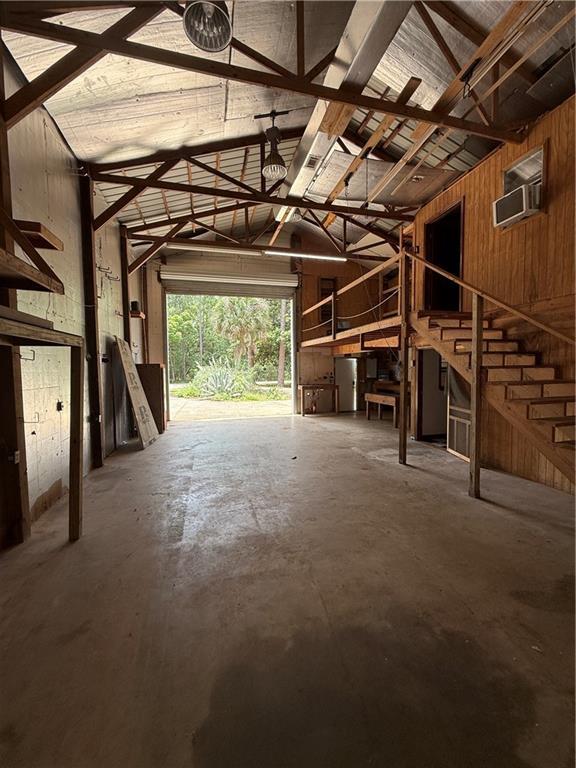 408 Chenault Ave, Dauphin Island, AL 36528 - garage featuring wooden walls and a wall mounted AC