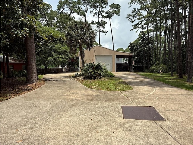 408 Chenault Ave, Dauphin Island, AL 36528 - view of side of home featuring concrete driveway, a detached garage, and an outdoor structure