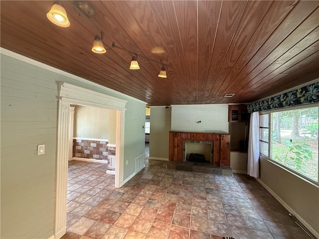 408 Chenault Ave, Dauphin Island, AL 36528 - unfurnished living room with wood ceiling and a fireplace with raised hearth