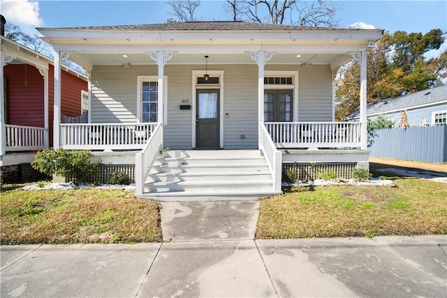 bungalow-style house featuring a front lawn and covered porch