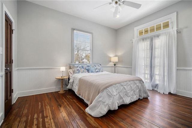 bedroom with ceiling fan and dark hardwood / wood-style flooring