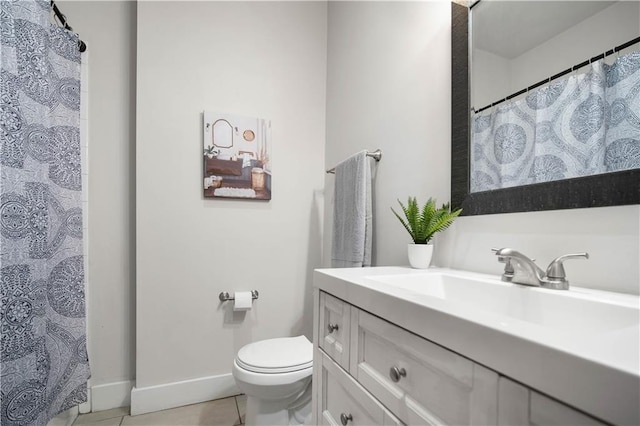 bathroom with vanity, tile patterned floors, and toilet