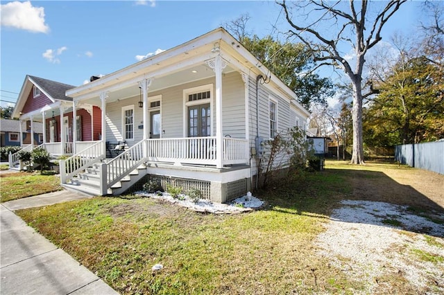 view of front of home featuring a front yard and covered porch