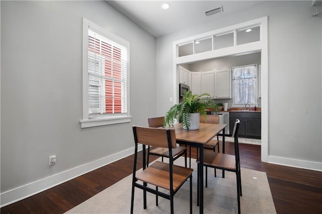 dining room with dark wood-type flooring