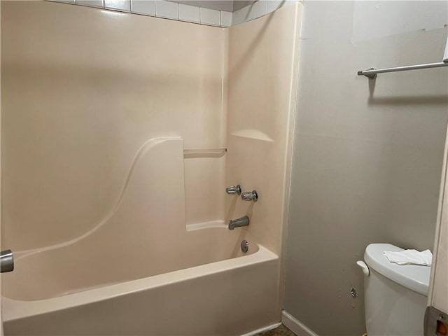 bathroom featuring shower / bathtub combination and toilet