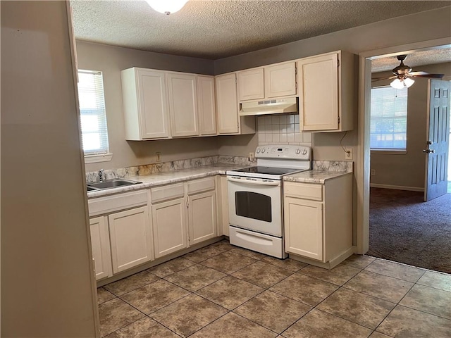 kitchen with carpet, white cabinets, sink, ceiling fan, and white electric range oven